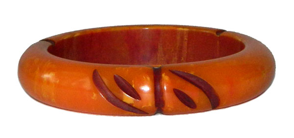 Carved orange bakelite bangle