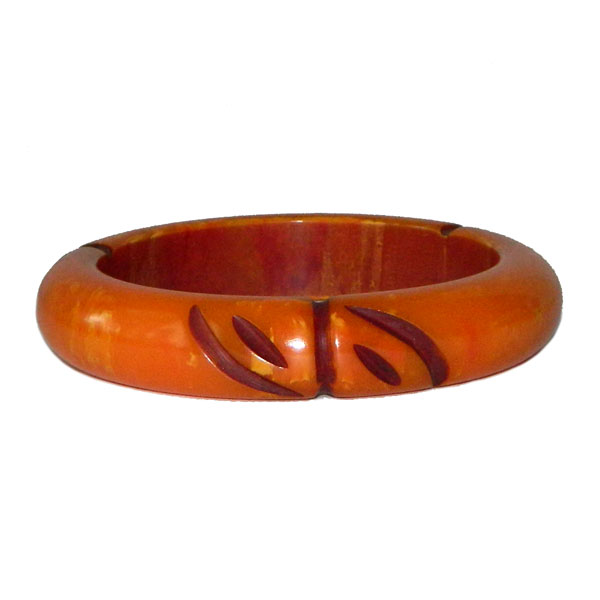 Carved orange bakelite bangle