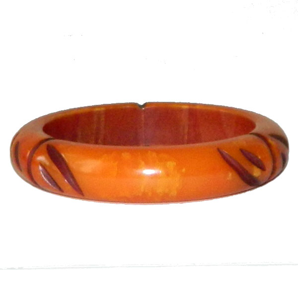 Carved orange bakelite bangle