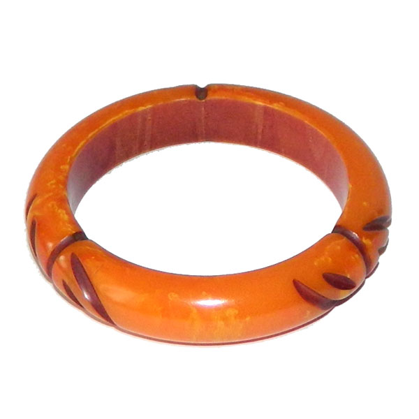 Carved orange bakelite bangle