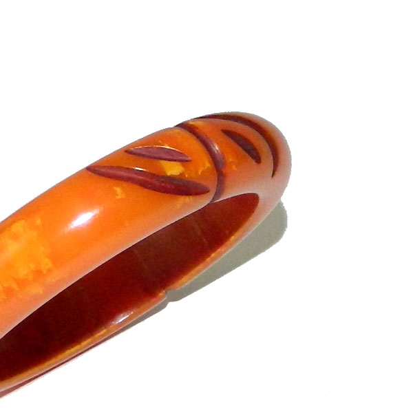 Carved orange bakelite bangle