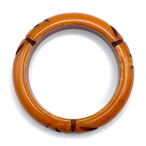 Carved orange bakelite bangle