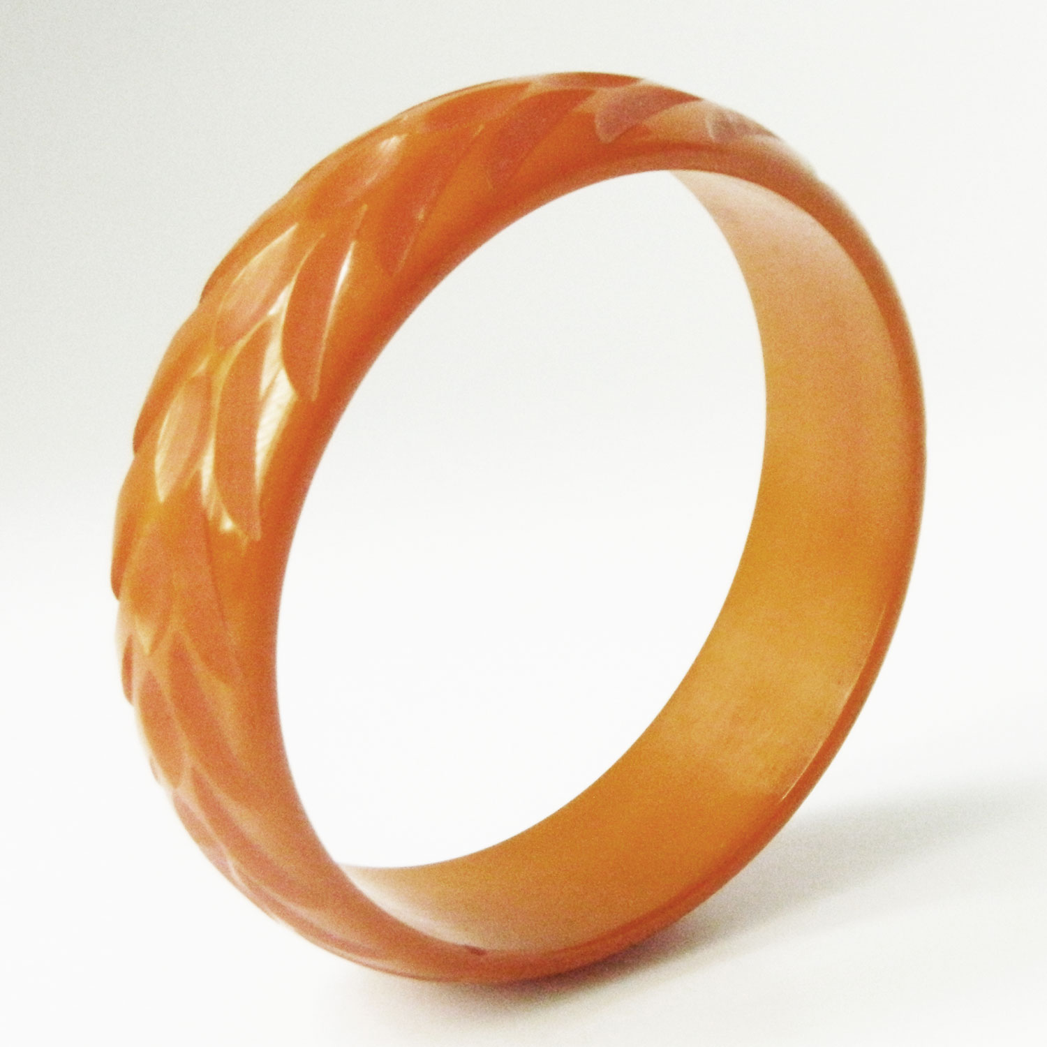 Carved orange bakelite bangle