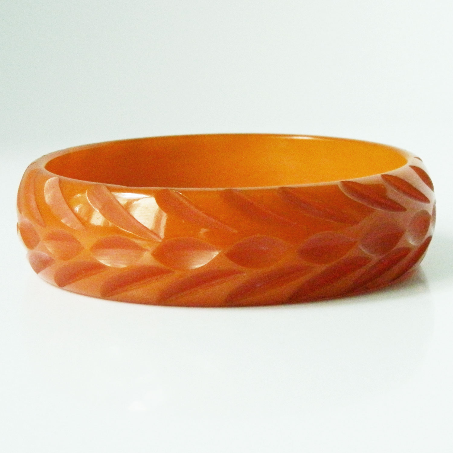 Carved orange bakelite bangle