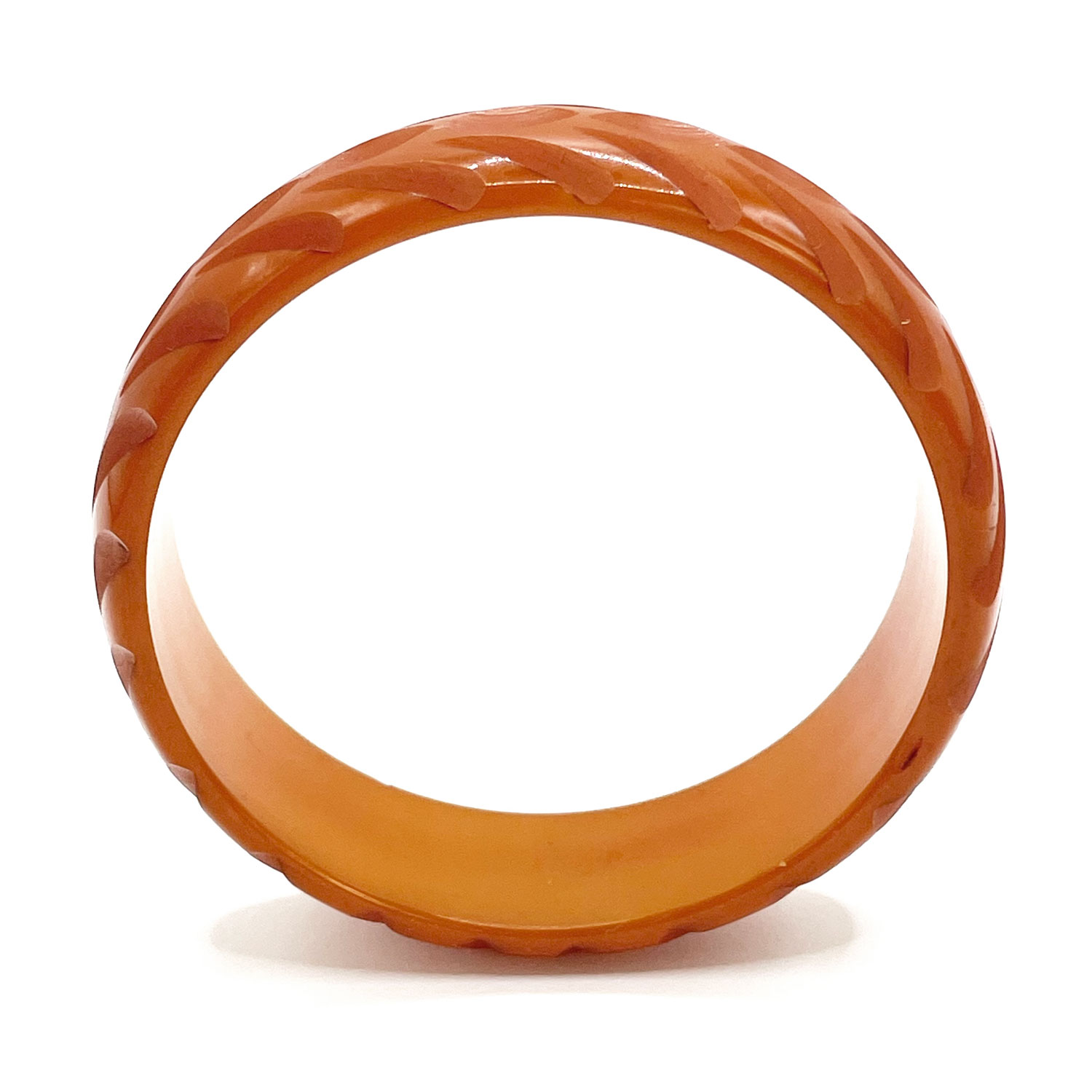 Carved orange bakelite bangle