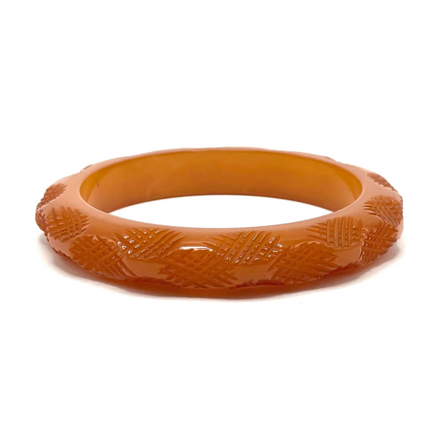 Carved burnt orange bakelite bangle