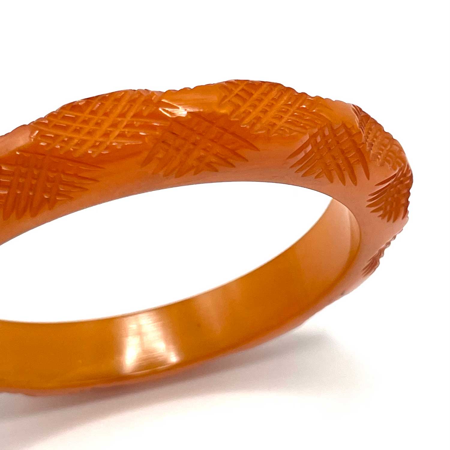 Carved burnt orange bakelite bangle