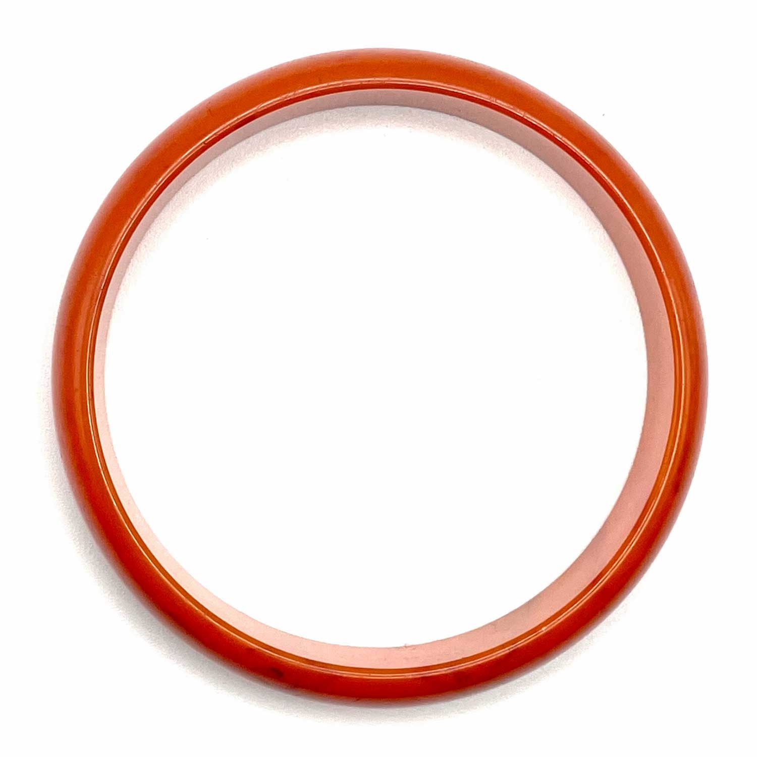 Carved orange swirl bakelite bangle