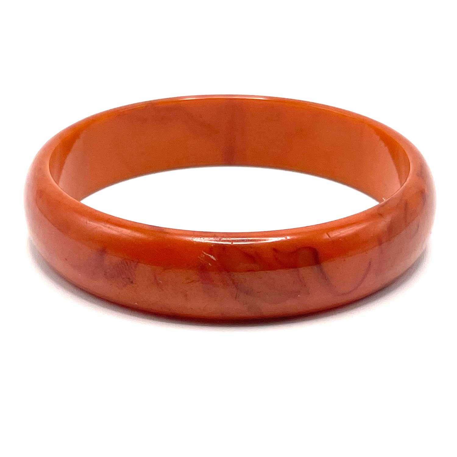 Carved orange swirl bakelite bangle