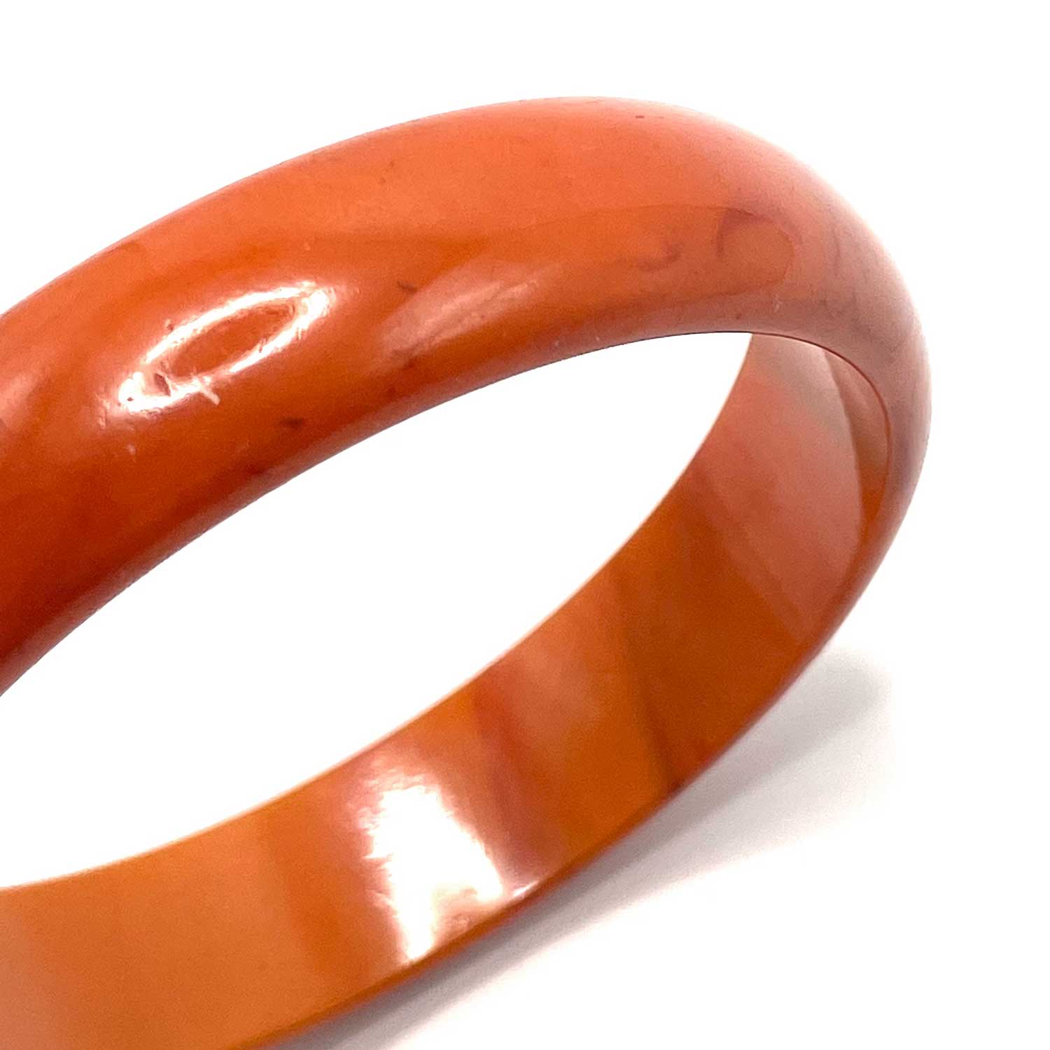 Carved orange swirl bakelite bangle