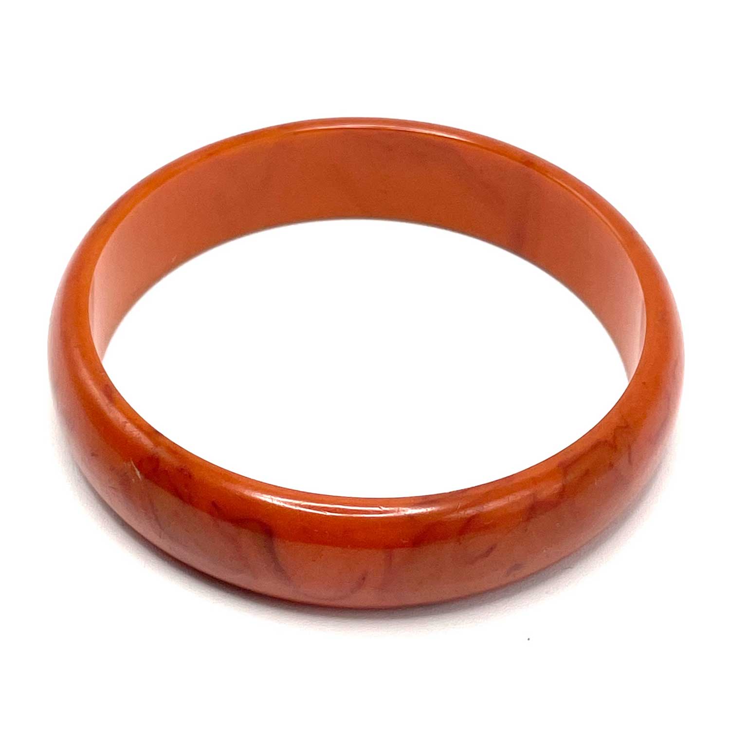 Carved orange swirl bakelite bangle