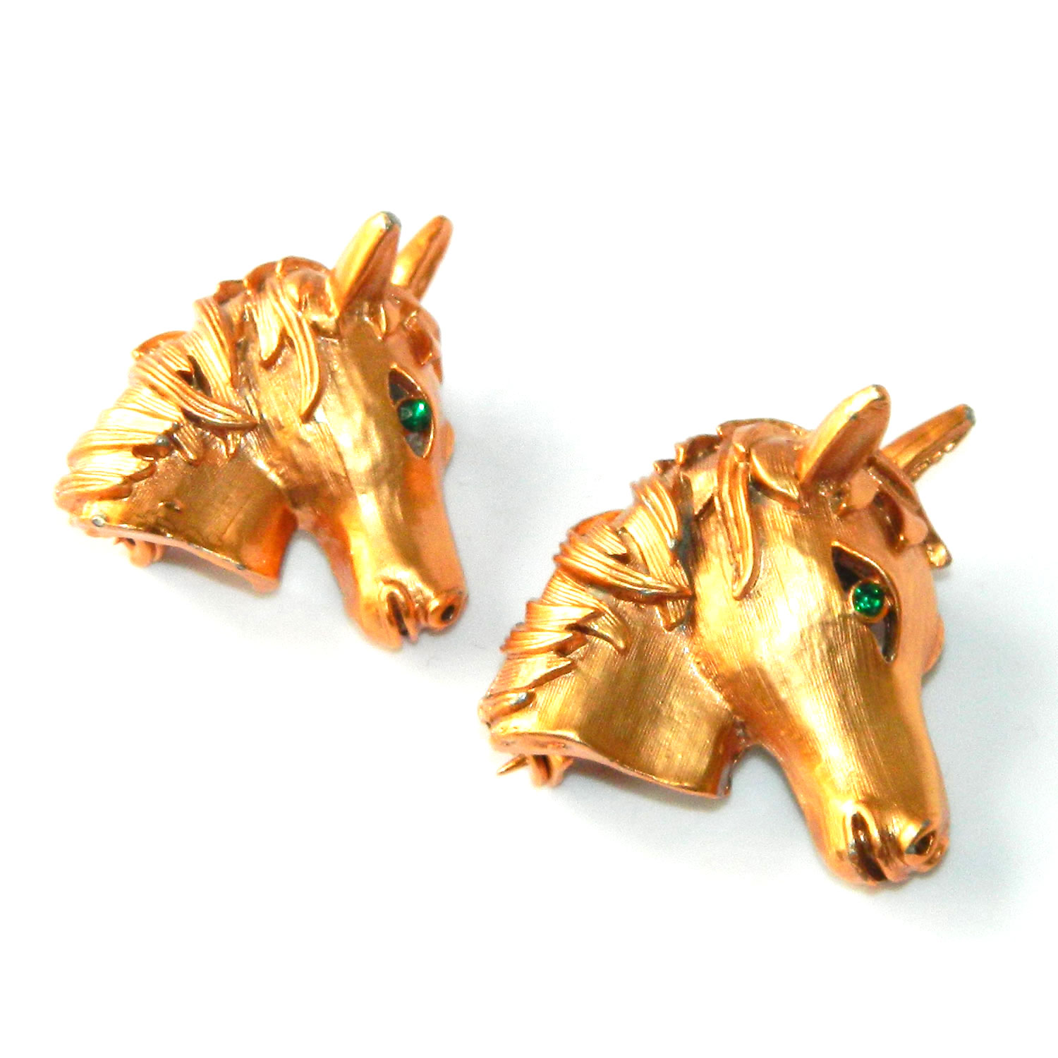 Pair of horse head brooches