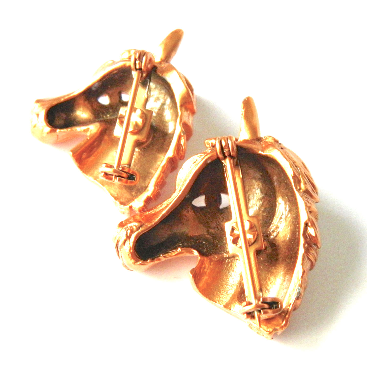 Pair of horse head brooches