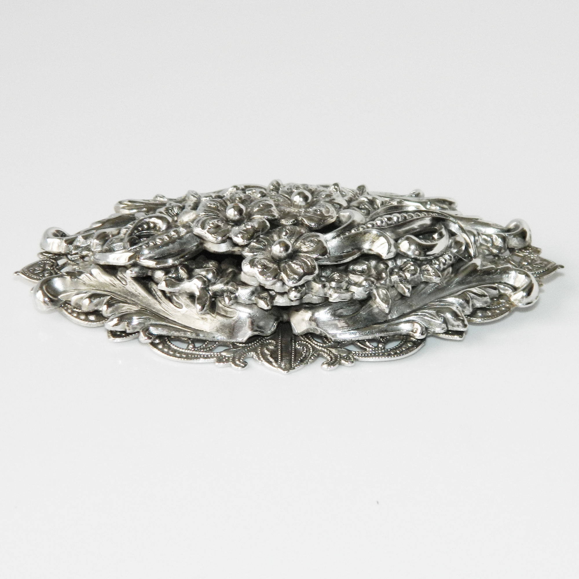 Silver metal floral brooch