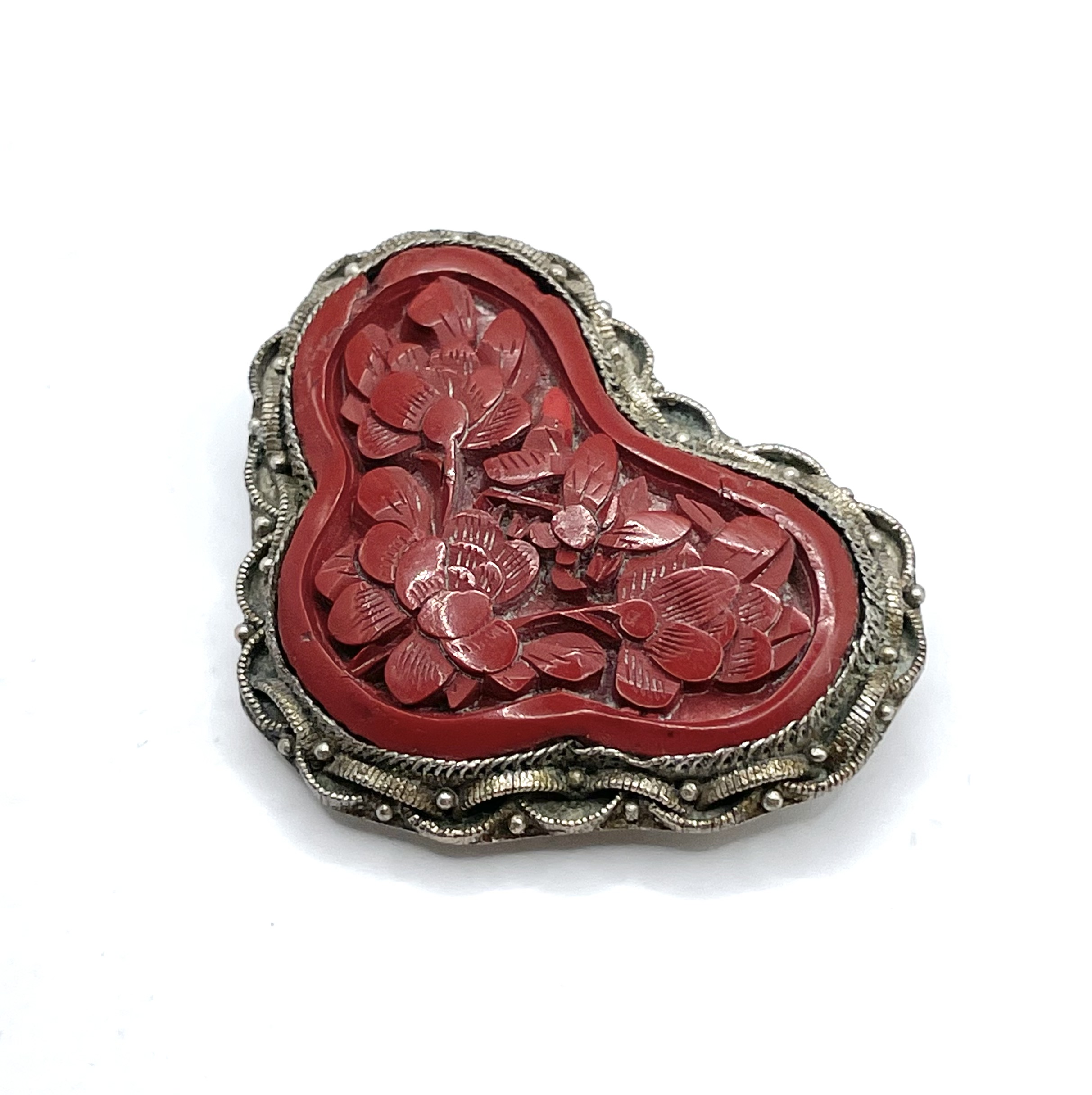Carved cinnabar dress clip