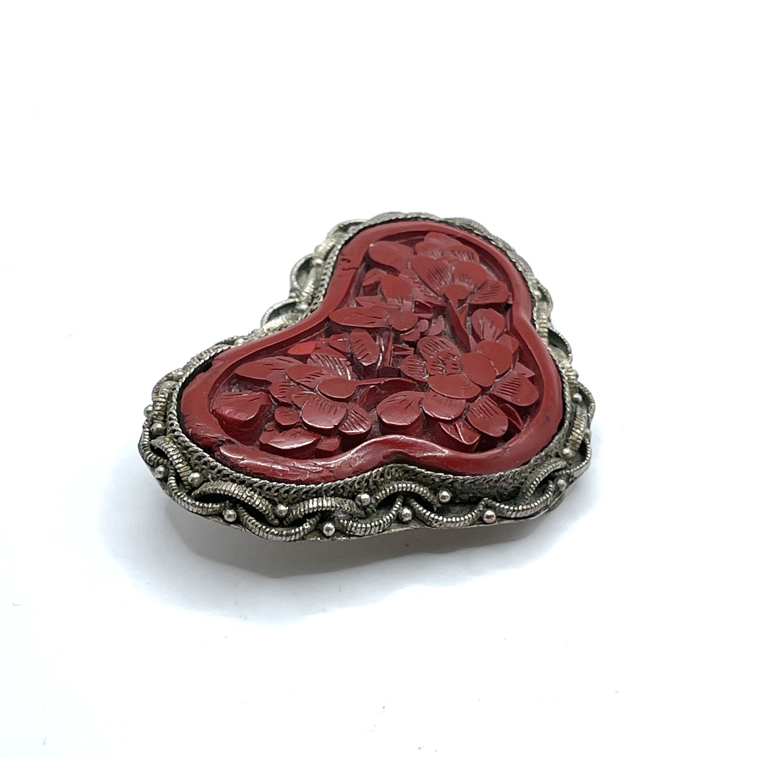 Carved cinnabar dress clip