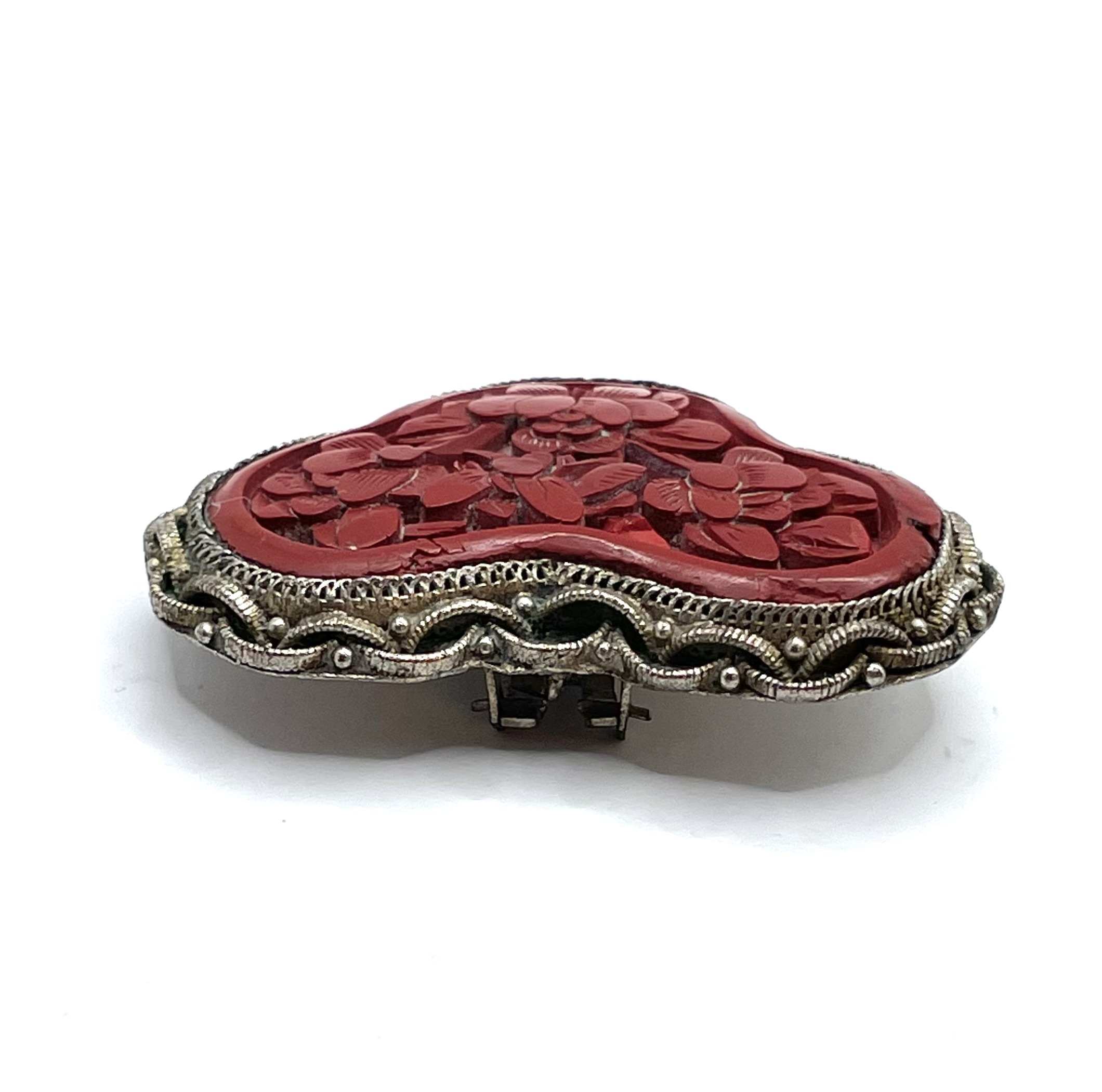 Carved cinnabar dress clip
